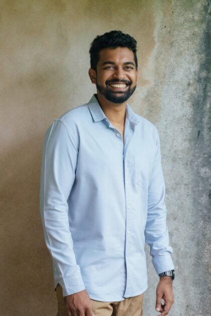 Smiling man in light blue shirt