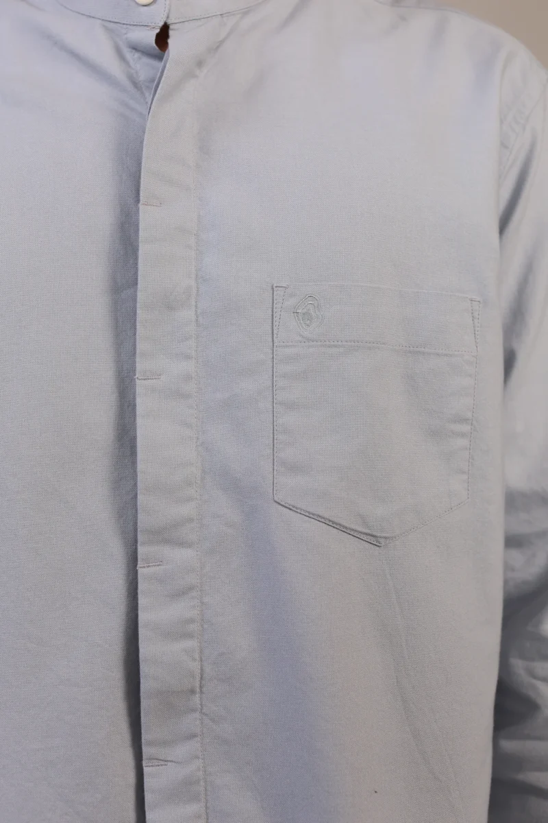 Close-up of powder blue shirt chest pocket.