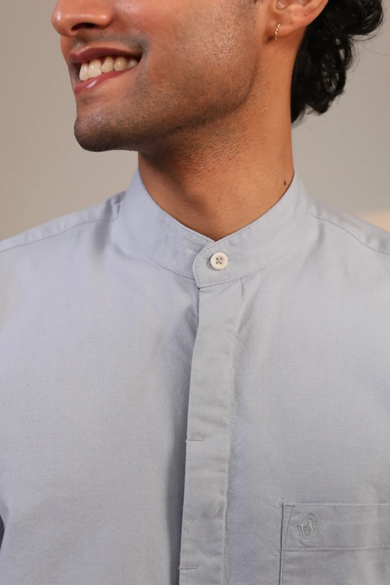 Close-up of powder blue mandarin collar shirt.