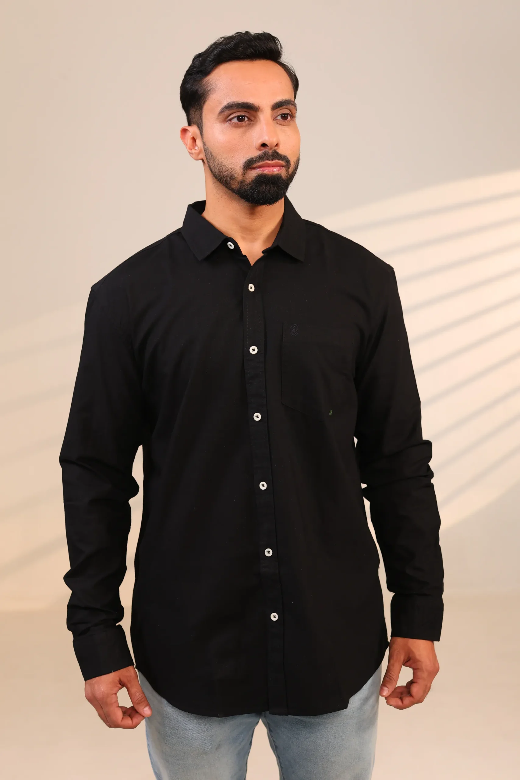 Man facing front in black shirt.