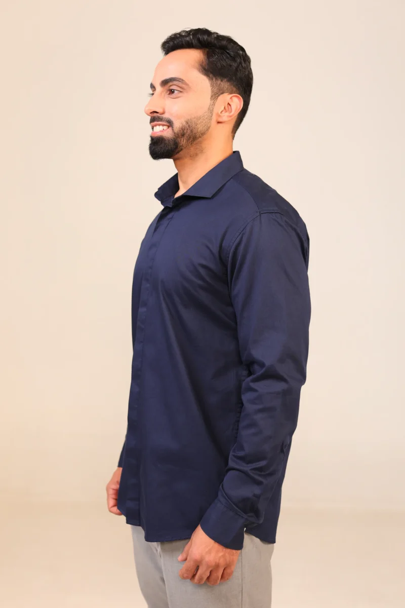 Man in navy shirt side profile view.