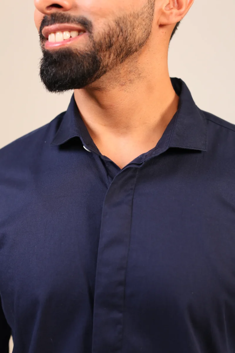 Close-up of navy shirt back and shoulder stitching.
