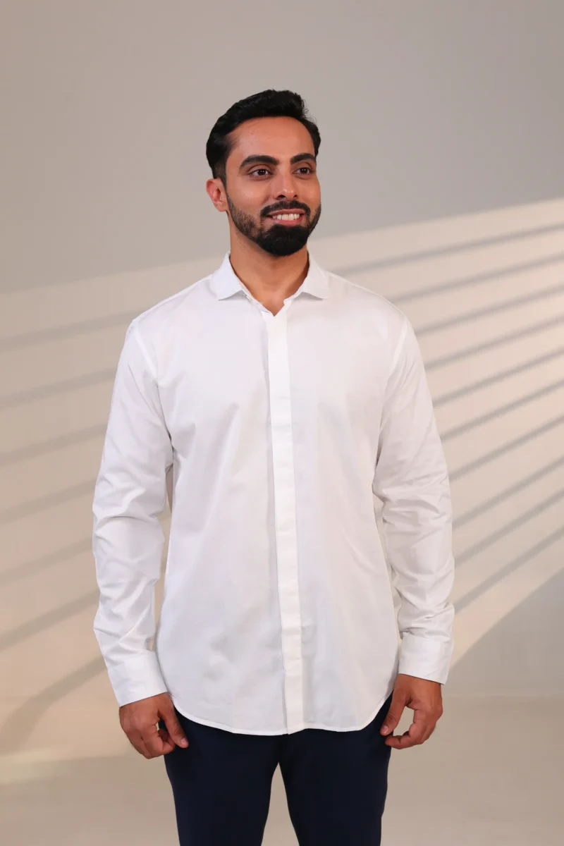 Man in white shirt looking slightly left.