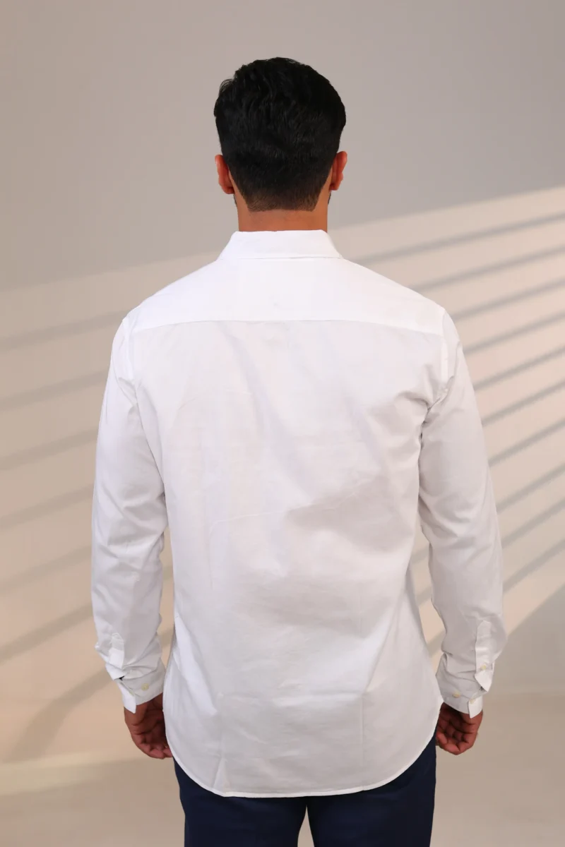 Rear view of man wearing a white shirt.