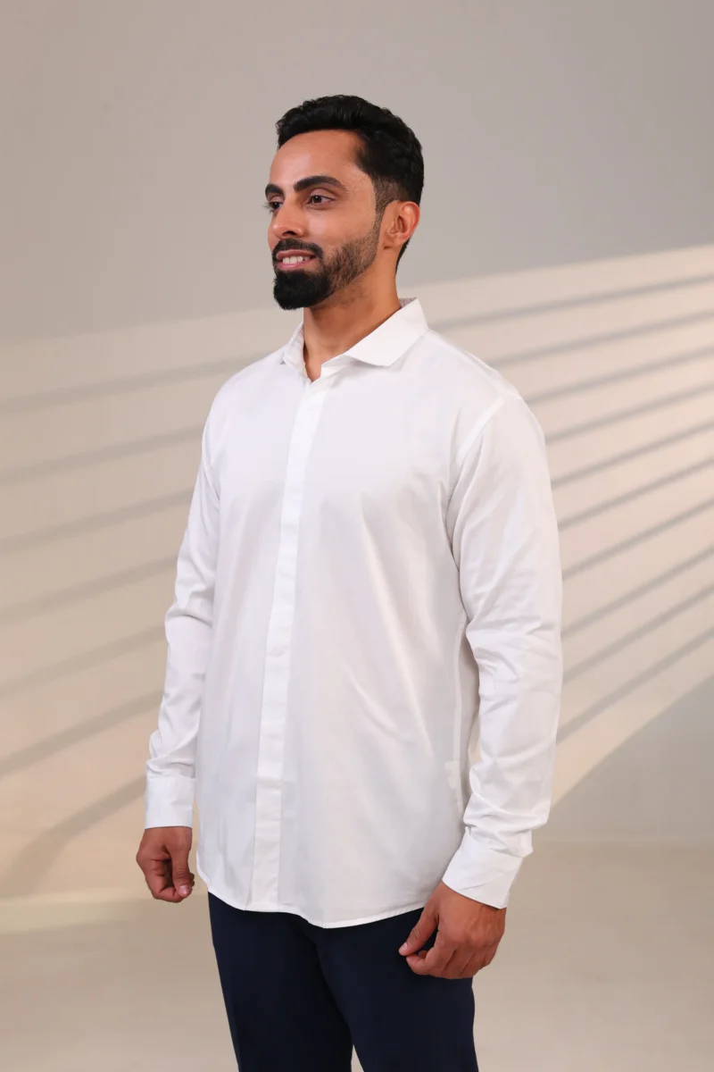 Man in a crisp white shirt standing facing forward.