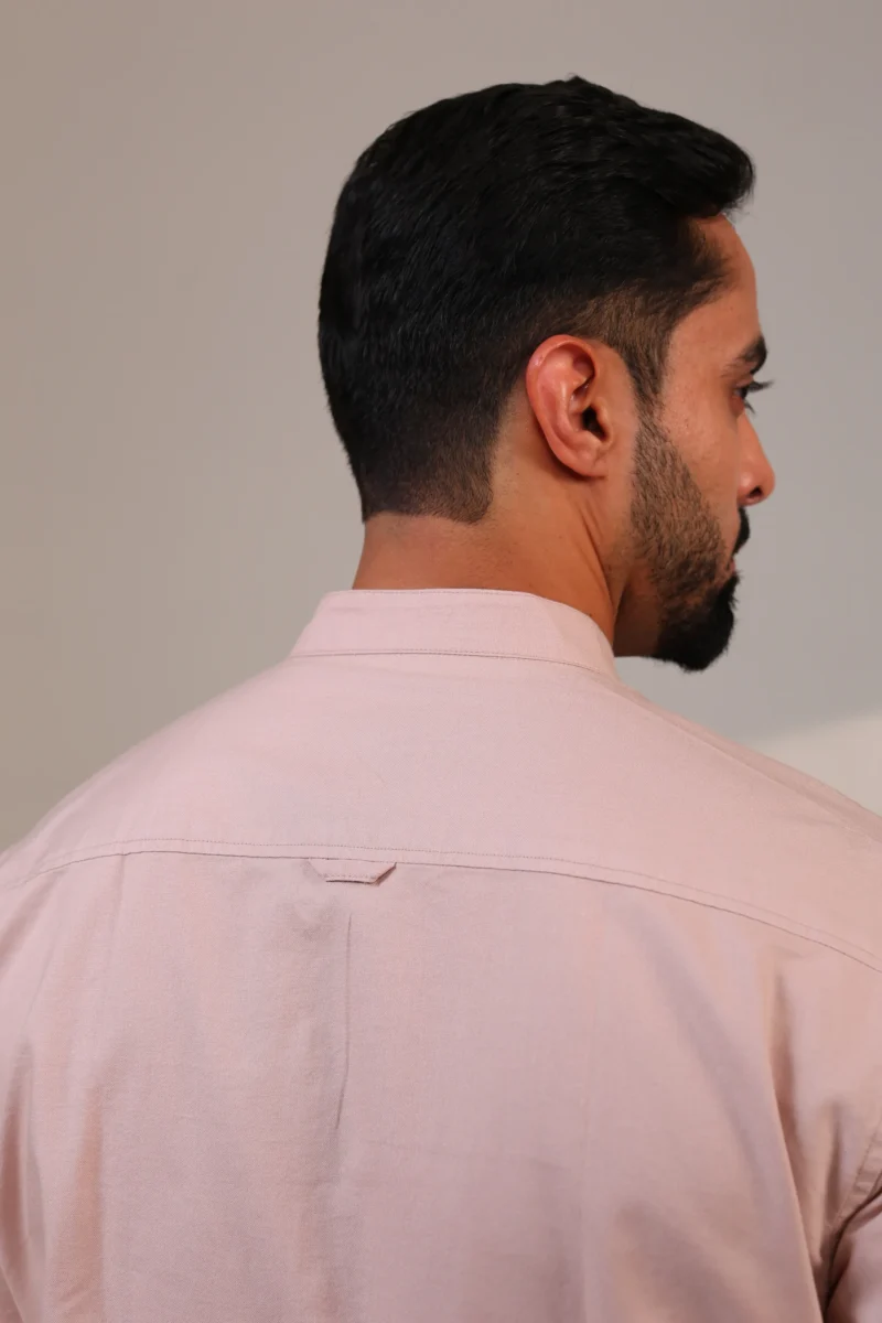 Back view of pink shirt with embroidered detail at collar.